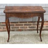 A 19th Century figured walnut fold-over card table, on slender cabriole supports, 33" wide