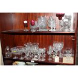 A collection of assorted drinking glasses, candlesticks etc
