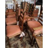 A set of eight (6+2) oak ladder back dining chairs with rush fitted loose cushions