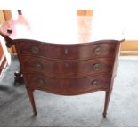 A reproduction mahogany serpentine front chest of three drawers with canted panelled sides, 35"
