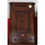 A 19th Century mahogany wall hung corner cabinet enclosed by plain panelled door with small draw