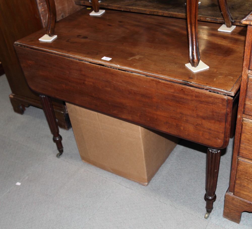 A William IV mahogany Pembroke table, fitted dummy drawers, on turned and reeded supports, 42" long