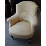 A Victorian low seat armchair, upholstered in a cream and gold fabric
