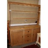 A 19th Century pine kitchen dresser, the back fitted two open shelves over three central drawers and
