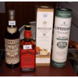 A bottle of Hennessy cognac, a bottle of Laphroaig 10 year old single Islay malt whisky, a bottle of