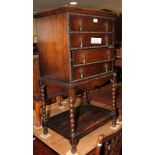 An early 20th Century oak four drawer sheet music cabinet, on bobbin turned supports with