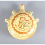 A Sussex slipware pilgrim flask with rose decoration, 8 1/2" high (surface chips and glaze faults)