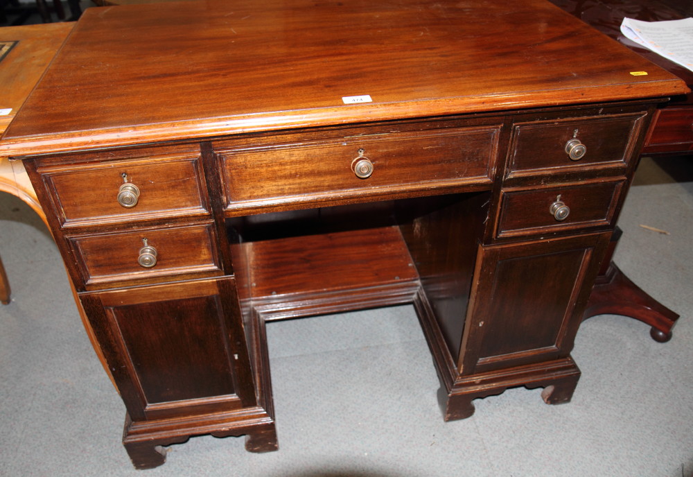 A 19th Century mahogany twin pedestal writing table, fitted five drawers and two cupboards, on