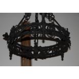 A wrought iron three-light ceiling pendant with thistle and rose decoration and three suspension