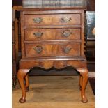 A bedside chest of three drawers with engraved brass handles, on cabriole supports, 18" wide