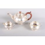 A silver three-piece teaset, the teapot with fruitwood knop and handle, 22.8oz troy approx
