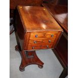 An early 19th Century mahogany and ebony strung drop leaf work table, fitted two drawers, on