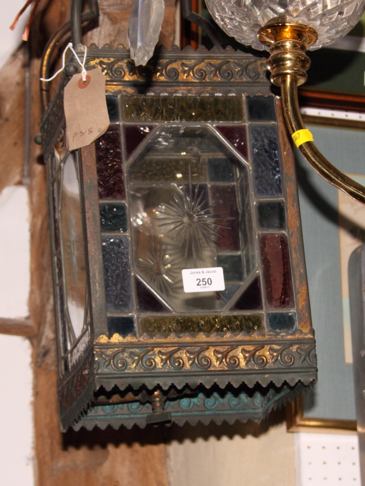 A Victorian square metal framed hall lantern, the sides decorated leaded glass panels, with original