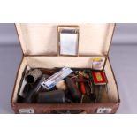 A collection of assorted pens, cigarette lighters, etc, in small brown attache case