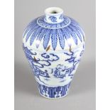 An 18th Century Chinese porcelain blue and white vase, decorated figures, buildings and clouds in