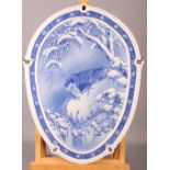 A 20th Century oval Japanese porcelain panel, painted eagle and capuchin monkey in a tree, 19" x