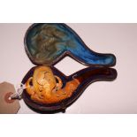 A 19th Century Meerschaum pipe, formed as a claw with "amber" mouthpiece, 4 1/2" long