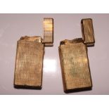 Two Dunhill gold plated cigarette lighters with leather cases