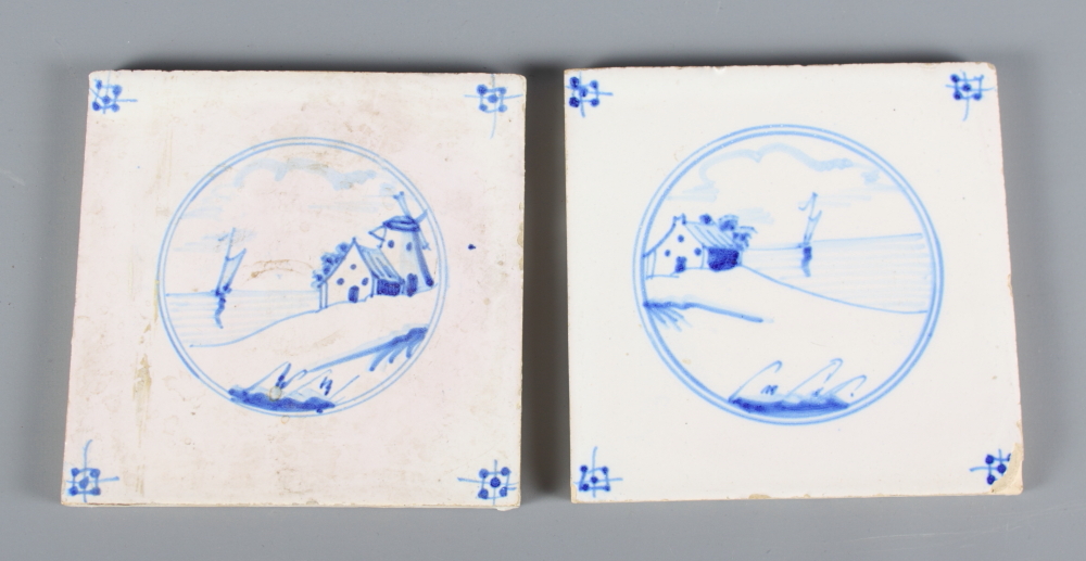 Two Delft wall tiles, decorated seascapes, and two 19th Century Meissen porcelain cups and saucers