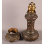 A Japanese bronze oil lamp with relief decoration, 18" high