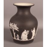 A 19th Century Wedgwood black basalt jasper dip vase decorated in the classical manner