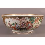 A Canton porcelain punch bowl with figure decoration, on a diaper ground (cracks)