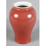 A Chinese porcelain baluster-shaped vase decorated sang de boeuf glaze, 7 1/2" high