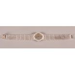 An 18ct white gold Piaget bracelet watch with silvered dial, baton numerals and diamond bezel, 48.1g