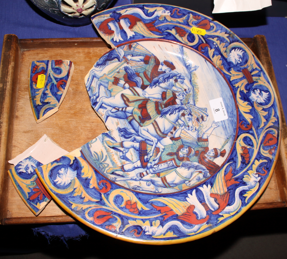 A Gubbio style faience dish, the centre painted Roman soldiers and horses, 15" dia (for restoration)