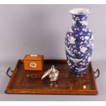 A glazed two-handled tray with inlaid Arts & Crafts design, a satinwood cigarette dispenser, a