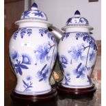 A pair of Chinese oviform blue and white jars and covers with floral decoration