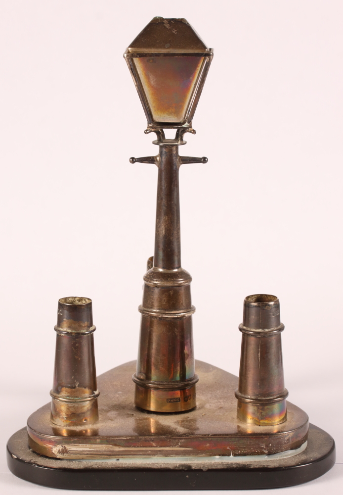 A Victorian silver desk stand (?), formed as a lamppost with three bollards, on triangular slate