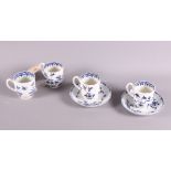 A set of four Worcester coffee cups decorated flowers in blue underglaze and a pair of 19th