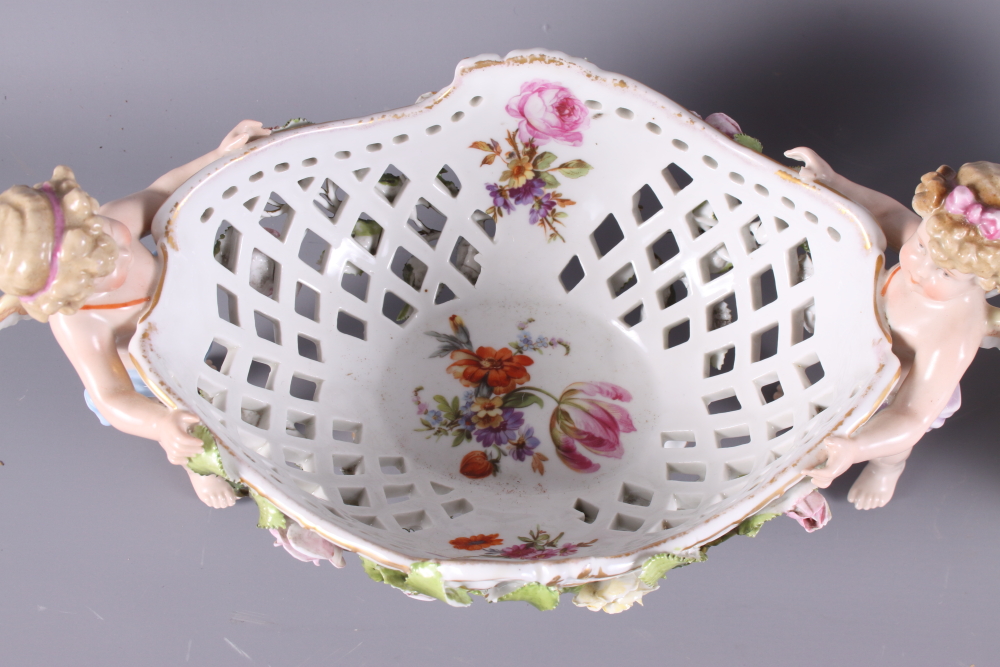 A mid 20th Century Continental porcelain table centre, basket with cherub supports and floral relief - Image 2 of 4