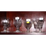 A pair of glass wine goblets, bowls cut ovals, and six other similar goblets