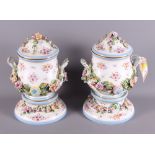 A pair of German porcelain two-handled vases, covers and stands with floral decoration in high