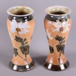 A pair of Doulton baluster vases with floral decoration, potter's marks for Emily Partington and