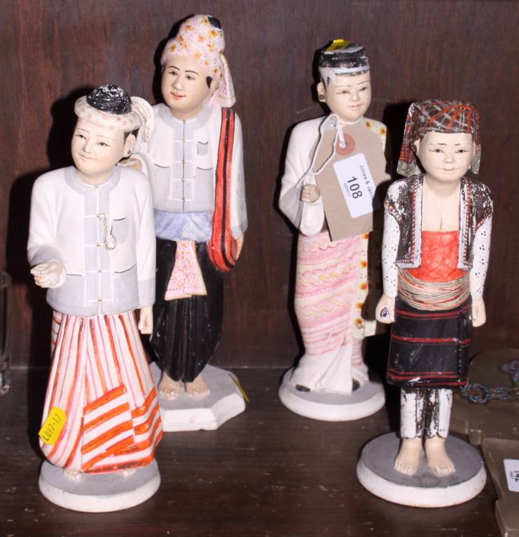 A set of four Burmese/Myanmar painted hardwood figures in traditional costume, 10" high