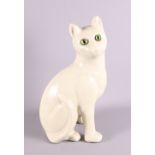 An Emile Galle monochrome glazed cat, with green glass eyes,13 1/2" high
