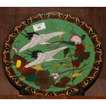 A Japanese cloisonne enamelled dish decorated two cranes in flight, 12" dia