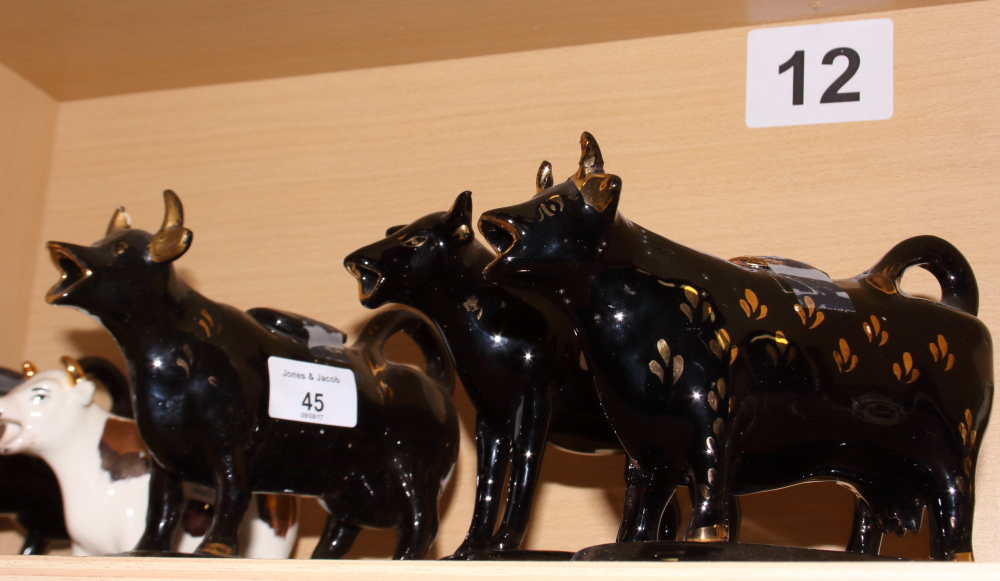 Four black and gilt decorated cow creamers and two others - Image 3 of 3