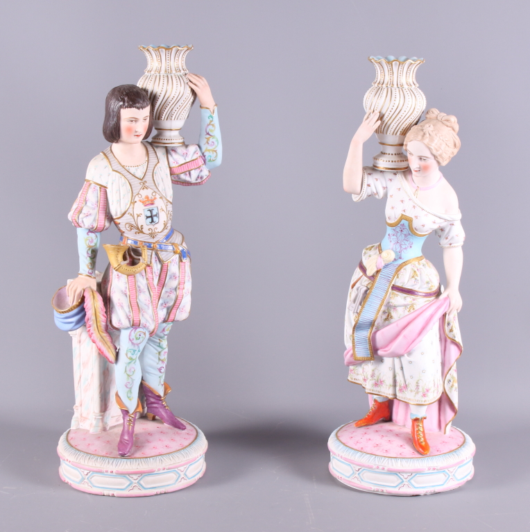 A pair of 19th century Continental polychrome bisque candlesticks, formed as figures in period