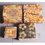 Four late medieval encaustic glazed floor tiles, different designs (one cracked)