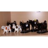 Four black and gilt decorated cow creamers and two others