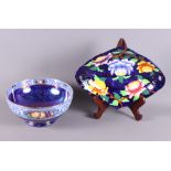 A Maling circular fruit bowl with blue lustre glaze and scroll and fruit decorated border, and