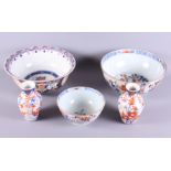 Three Imari decorated bowls, the largest 9" dia, and a pair of Imari decorated vases (cracks and