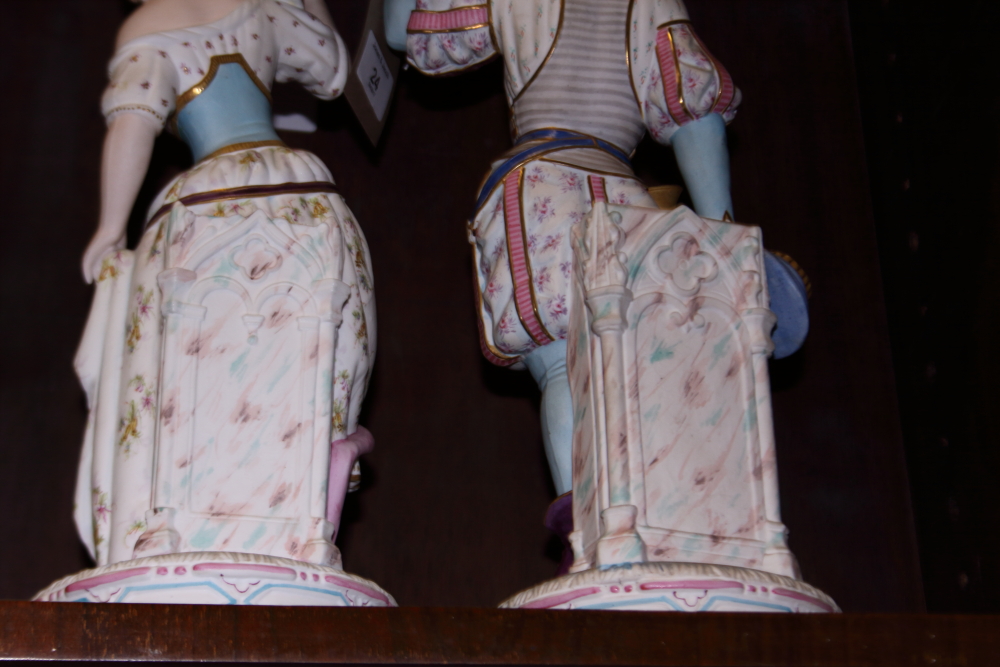 A pair of 19th century Continental polychrome bisque candlesticks, formed as figures in period - Image 9 of 11