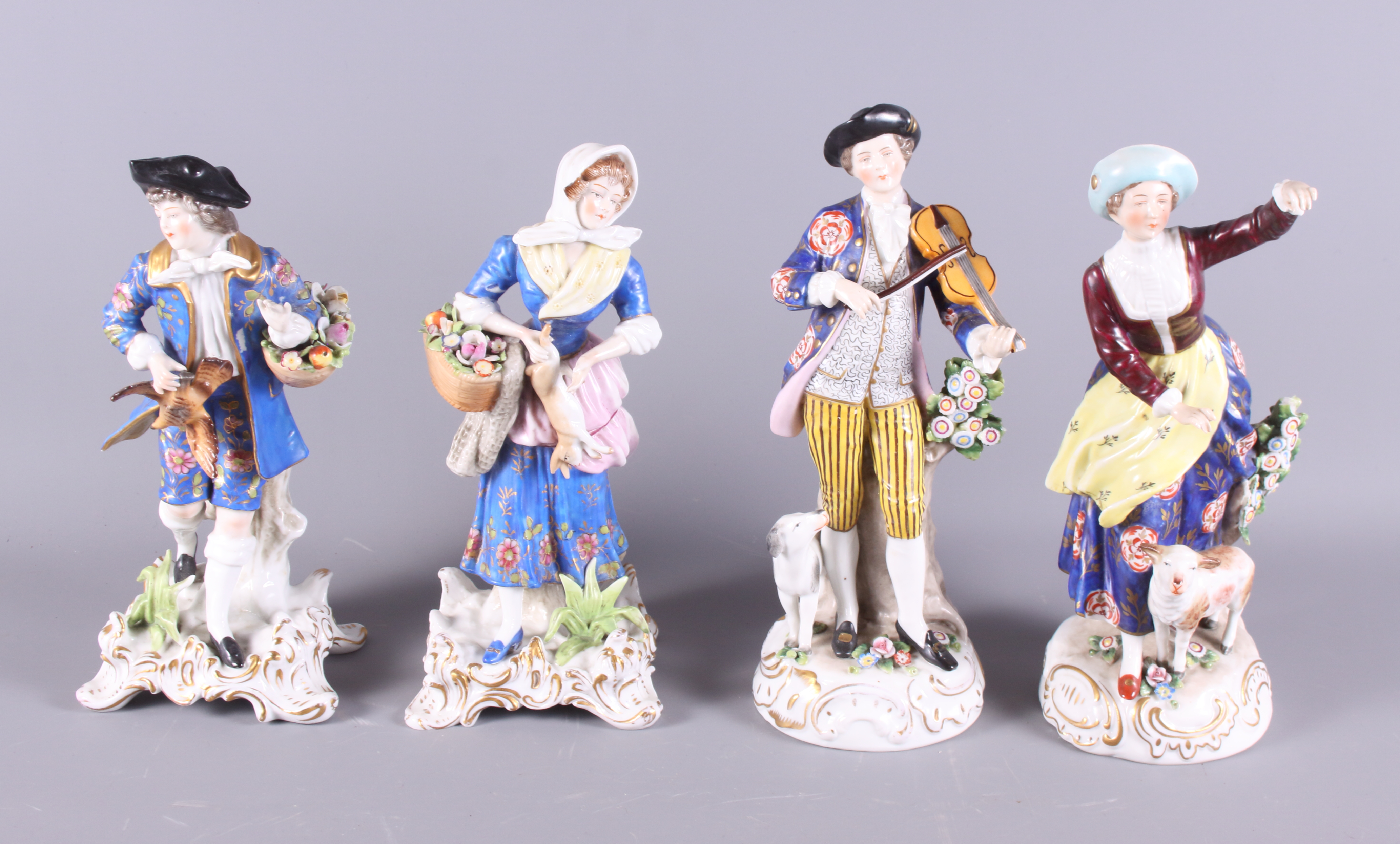 A pair of Continental porcelain figures, shepherdess and musician, 9" high, and a similar pair, on