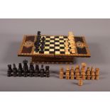 Two carved wooden chess sets (one incomplete) and an inlaid travelling chessboard