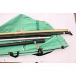 Five metal and plastic fishing rod carry cases and a green canvas fishing rod carry roll